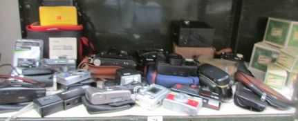 A shelf of assorted camera's etc.