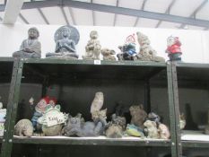 2 shelves of garden ornaments including gnomes.