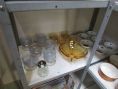 A shelf of glass and china fruit bowls etc.