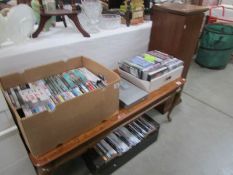 A Sony DVD player, 3 boxes of DVD's and a storage cabinet.