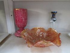 A carnival glass bowl and 2 other glass items.