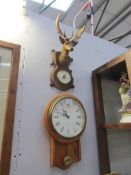 A wall clock and a stag head barometer.