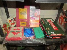 A shelf of games including scrabble.