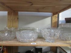 A shelf of assorted glass bowls,