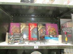 A mixed lot of collectable's including Hunger Games books, a Stranger Things T Shirt,