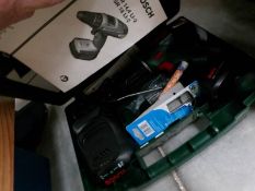 A cased Bosch power drill,.