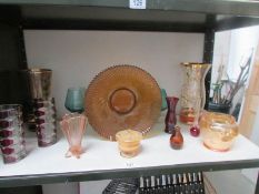 A shelf of assorted glass ware.