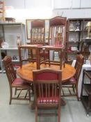 An oak circular dining table and 6 chairs.