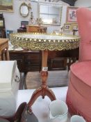 A circular table with marble top and gilt gallery.