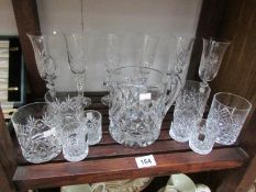 A shelf of assorted glass ware.