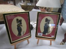A pair of framed and glazed silhouettes of soldiers.