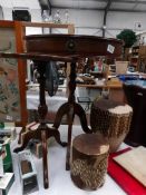 A small drum table and a wine table.