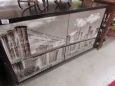 A 2 door cupboard with New York scene featuring Brooklyn Bridge
