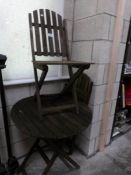 A folding garden table and 2 chairs.