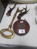 A pair of short antlers, a large brass key and a Chesterman rule.