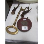 A pair of short antlers, a large brass key and a Chesterman rule.
