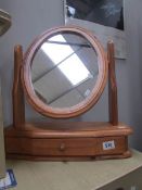 A pine toilet mirror with drawer.