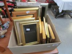 A quantity of small gilded photograph and picture frames.