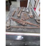 A work bench together with a quantity of heavy/large adjustable wrenches,