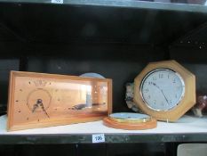 A shelf of assorted clocks.