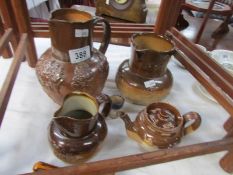 3 stoneware jugs, a stoneware teapot and a miniature stoneware jug, some a/f.