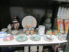 A shelf of assorted oriental porcelain.