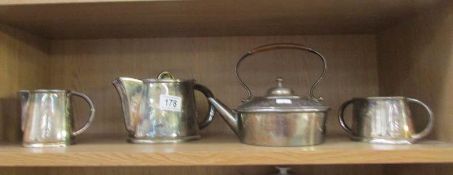 A silver plate tea set and kettle.