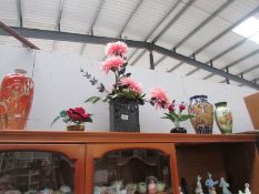 A quantity of vases some with silk flowers.