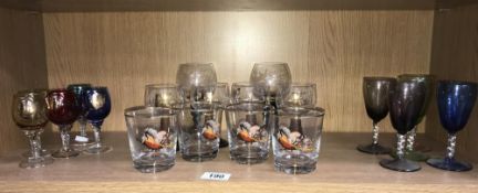 A shelf of drinking glasses including pheasant decorated.