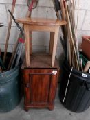 A pot cupboard (missing top) and a small table.