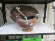 A large copper tray and a copper coal scuttle.