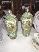 A pair of hexagonal lidded vases in an oriental style.