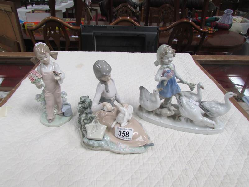 2 Lladro figures and one other.