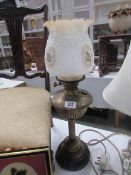 A brass oil lamp with pot base complete with shade and chimney.