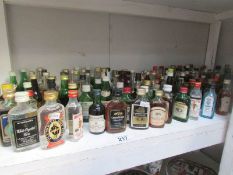 A shelf of alcohol miniatures.