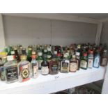 A shelf of alcohol miniatures.