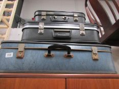 3 vintage suitcases.