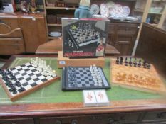 An electronic chess set, 2 other chess sets etc.