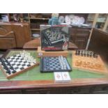 An electronic chess set, 2 other chess sets etc.