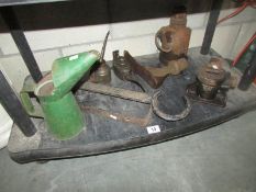 A shelf of car related items including jacks etc.