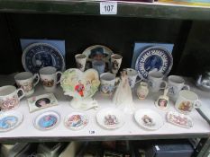 A shelf of commemorative china.