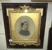 A Victorian gilt framed portrait of an elderly lady in a glass case.