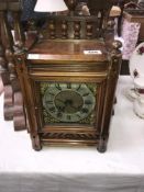 An oak cased mantel clock with 3 stars marked to mechanism.