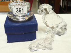2 glass dogs and a candle holder.