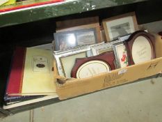 A box of photo frames and photo albums etc.