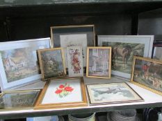 A shelf of assorted prints.