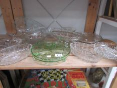 A shelf of glass ware including cake stands.