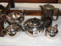 A silver plate 3 piece tea set and 2 other items.