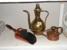 A copper scoop, a brass pot and a copper watering can.
