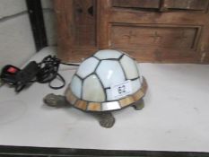 A Tiffany style lamp in the shape of a tortoise.